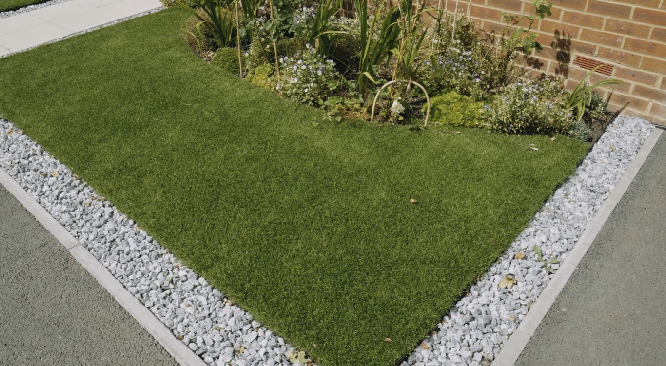 Eco-friendly artificial grass installation with gravel border